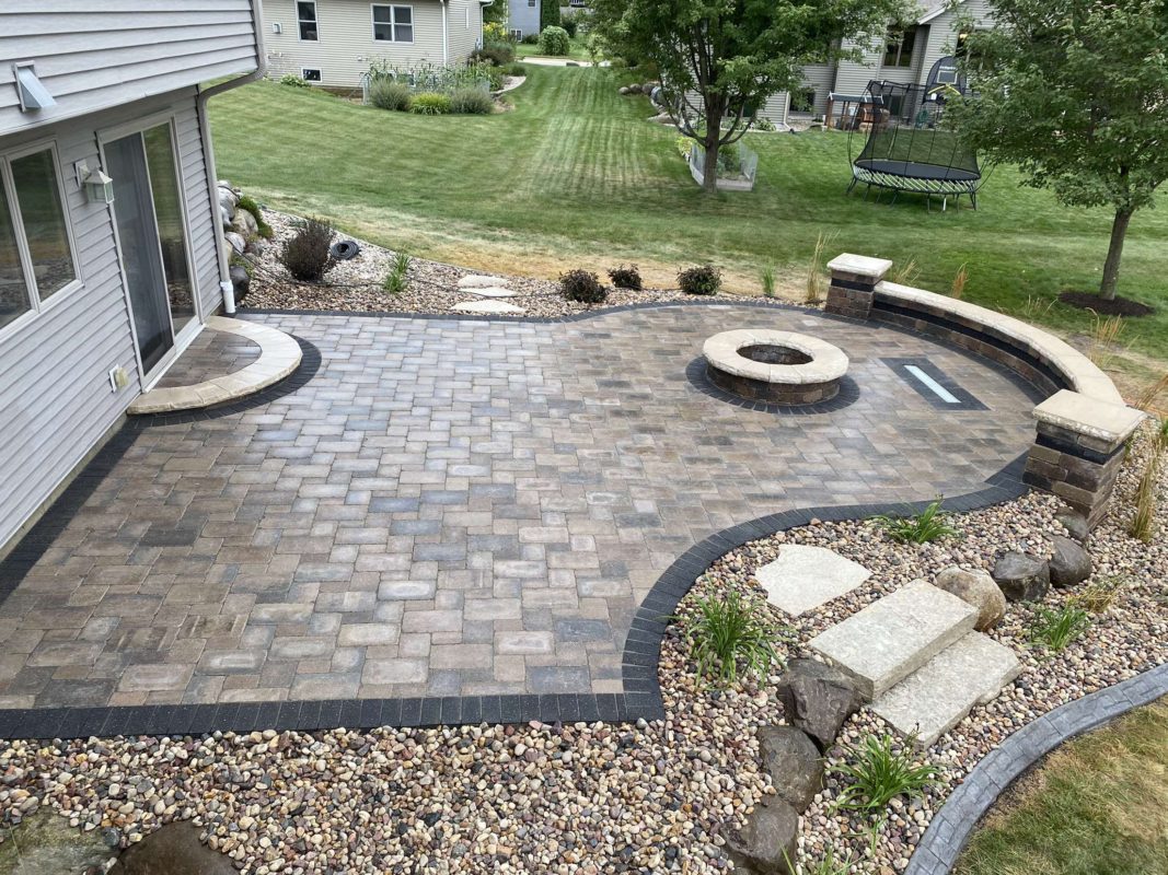 Brick patio with fire pit and river rock